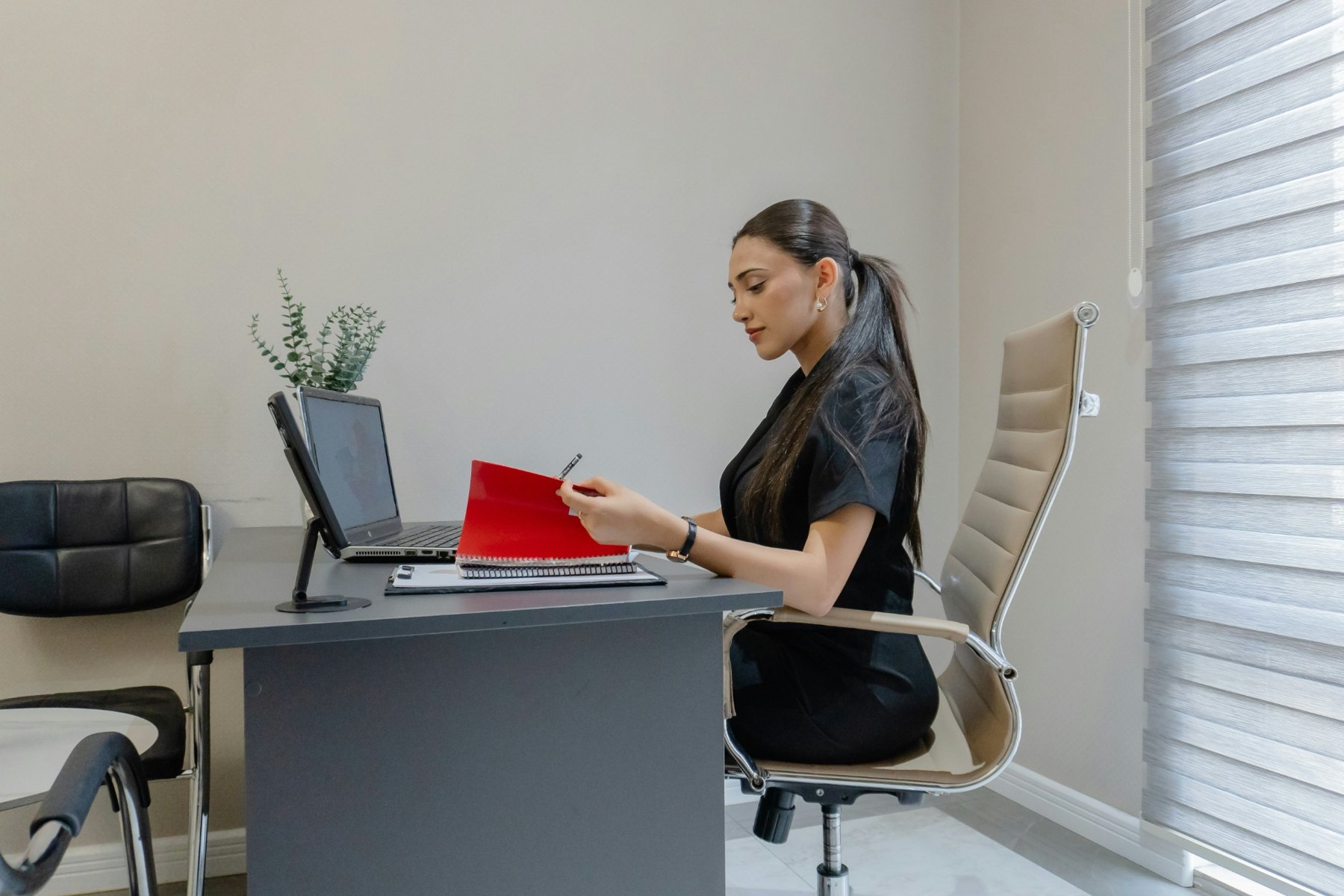 Professional reviewing records at a desk